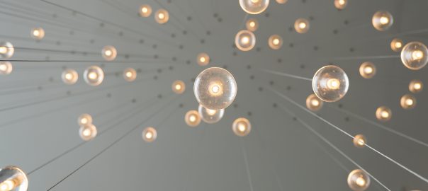 Lightbulbs hanging from strings on ceiling